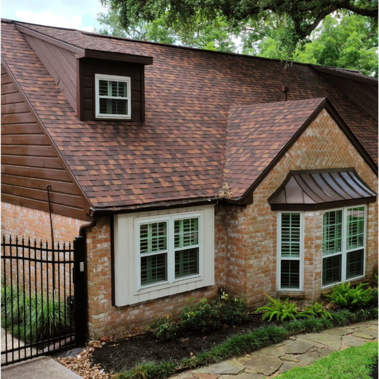 red-brown shingle roof on brick home