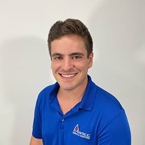 A young man with short brown hair, wearing a bright blue polo shirt with the logo