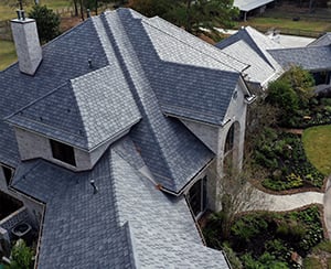 overhead view of large home with gray composite roof