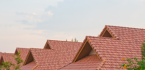 red tile roof white light blue sky background