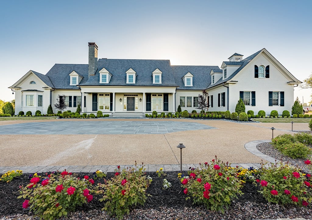 large white home with many windows and gray composite roof