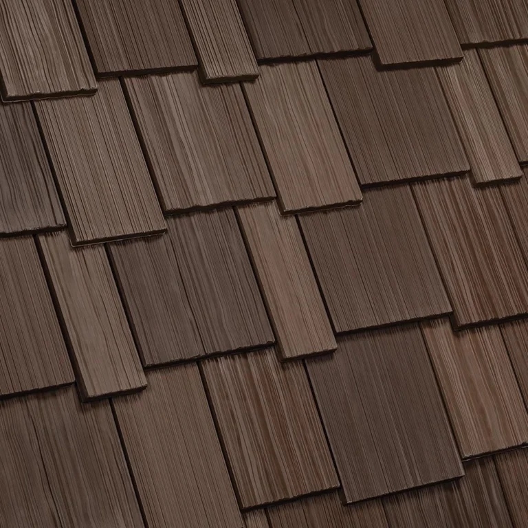 A close-up view of a wooden shingle roof with overlapping rectangular shingles. The shingles are in shades of brown, varying slightly in tone and texture, giving the roof a rustic and classic appearance.