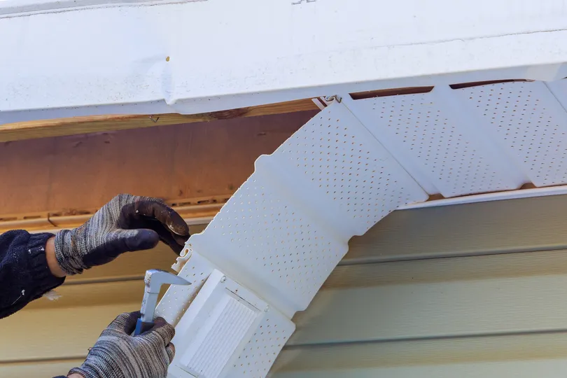 damaged white roof fascia being inspected and taken down