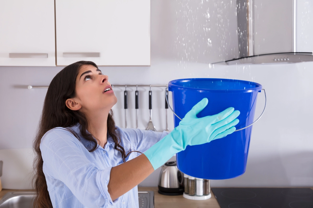 A woman holding a bucket of water, Houston roof replacement on her mind, ready to tackle the next big project.