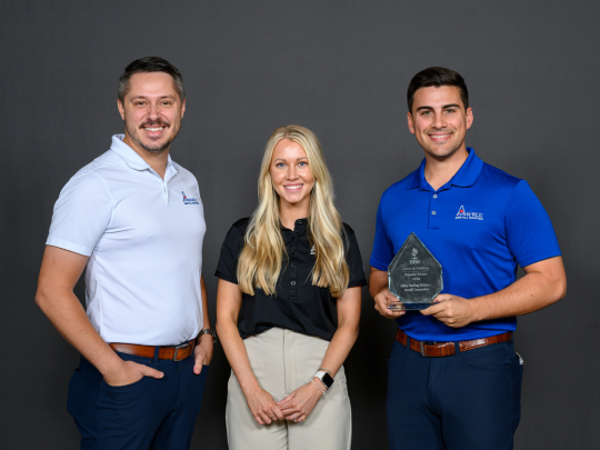 Sam Stilley, Lindsey, and Charlie proudly accept an award from the Better Business Bureau, recognizing Amstill Roofing as one of the best roofers in Houston.