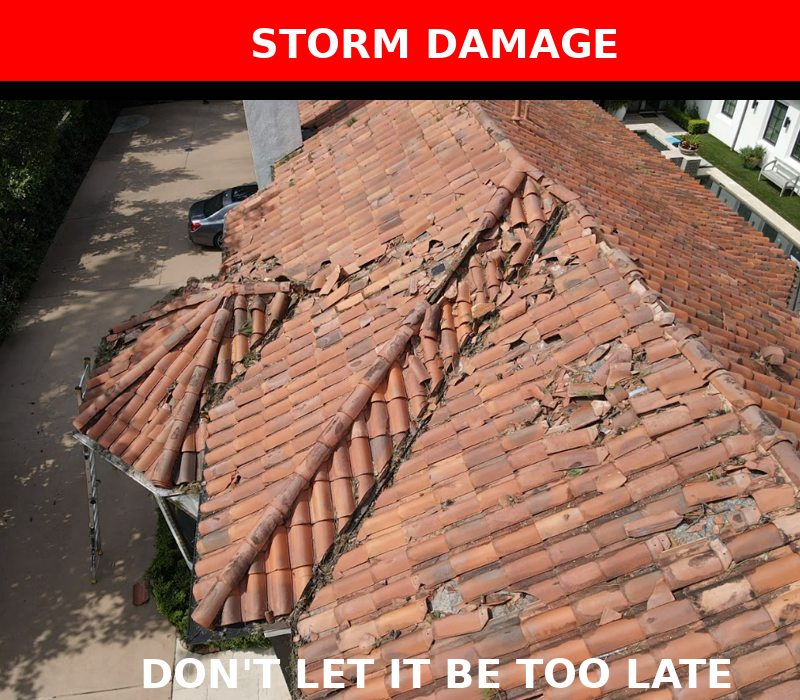A damaged clay tile roof with multiple broken and missing tiles, caused by storm impact and requiring immediate repair.